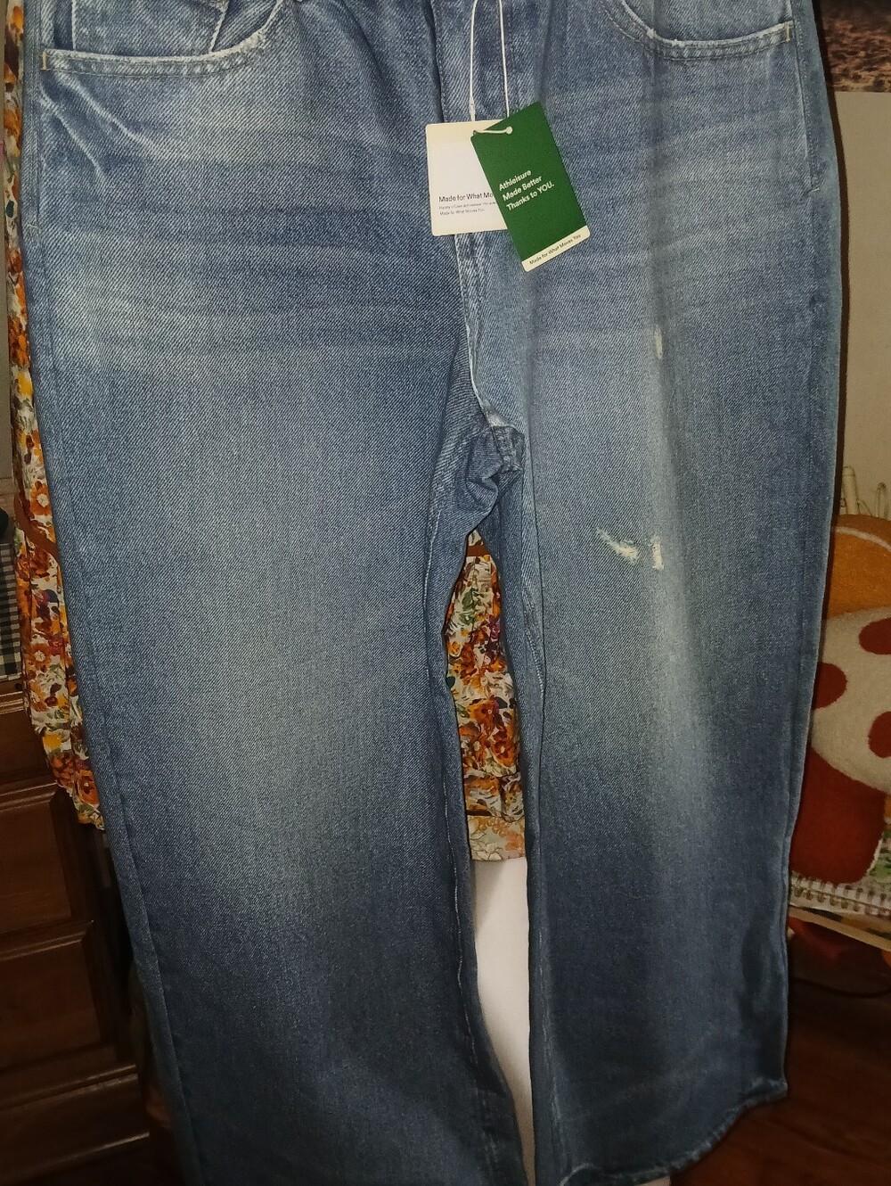 HALARA denim jeans with dark green tag and cream hang tag